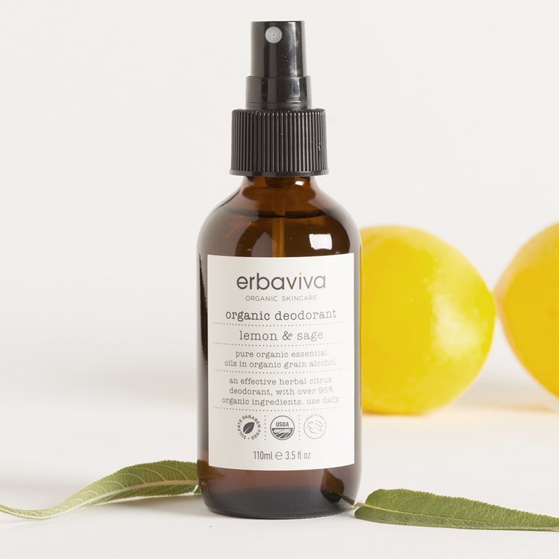 Lifestyle shot of Erbaviva Lemon & Sage Organic Deodorant (3.5 oz) with lemons in the background and sage in the foreground