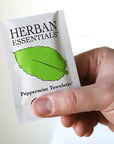 Model holding Herban Essentials Peppermint Towelette