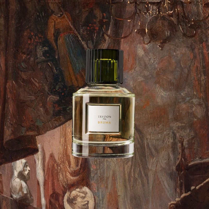 Image of Trudon Bruma Eau de Parfum (100 ml) with illustration of wall hangings, tapestry and chandelier in the background