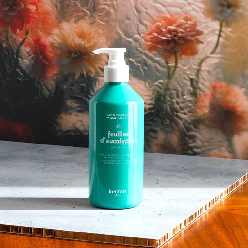 lifestyle shot of Kerzon Liquid Body Soap - Feuille d&#39;Eucalyptus (16.67 oz) with flowers in the background