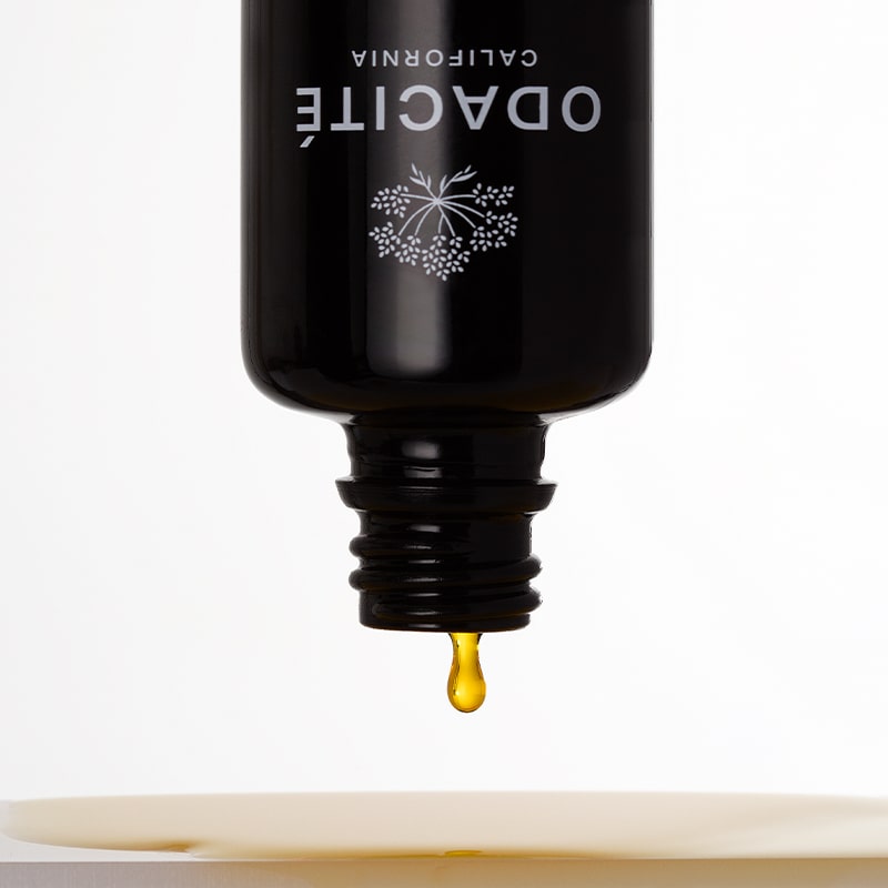 Odacite All-Embracing Hydrating Serum - product shown with serum dripping out