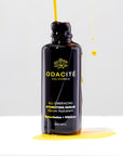 Odacite All-Embracing Hydrating Serum - product shown with serum dripping on bottle