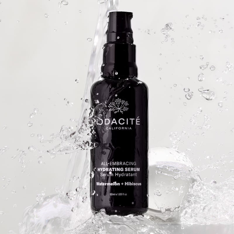 Odacite All-Embracing Hydrating Serum - product shown with water splashing on it