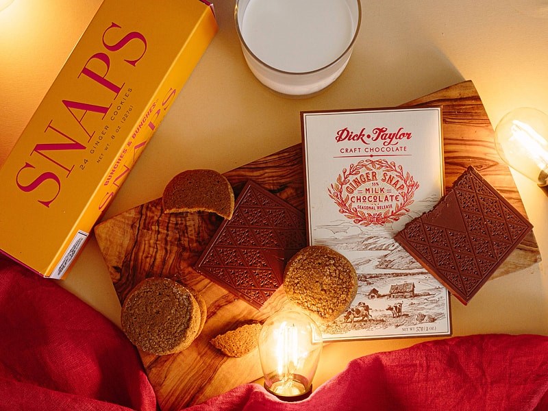 Dick Taylor Craft Chocolate Ginger Snap Milk Chocolate - product shown next to cookies and light bulbs