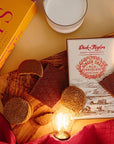 Dick Taylor Craft Chocolate Ginger Snap Milk Chocolate - product shown next to cookies and light bulbs