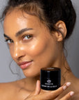 Model holding Odacite Creme de la Nuit (50 ml) close to her face