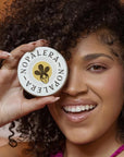 Close up of model holding Nopalera Botanical Lotion Bar (2 oz)