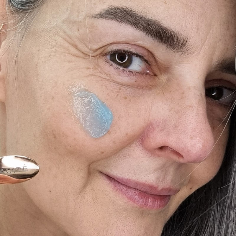 Odacite Le Blue Balm smear shown on cheek of model