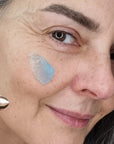 Odacite Le Blue Balm smear shown on cheek of model