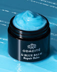 Odacite Le Blue Balm (50 ml) showing balm in container with balm in the background