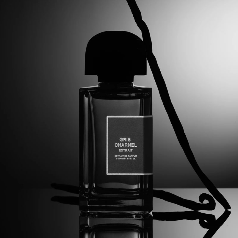 Lifestyle mood shot of BDK Parfums Gris Charnel Extrait (100 ml) bottle with vanilla bean pods in the background