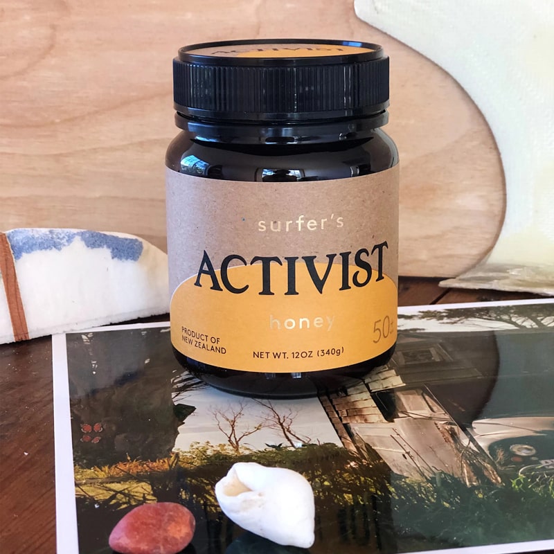 Lifestyle shot of Activist Manuka Surfer&#39;s Honey 50+MGO (12 oz)