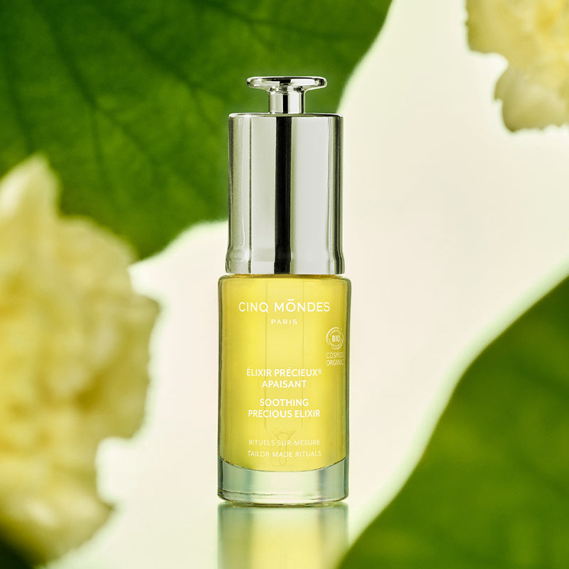 Cinq Mondes Soothing Precious Elixir Facial Oil - product shown next to plants