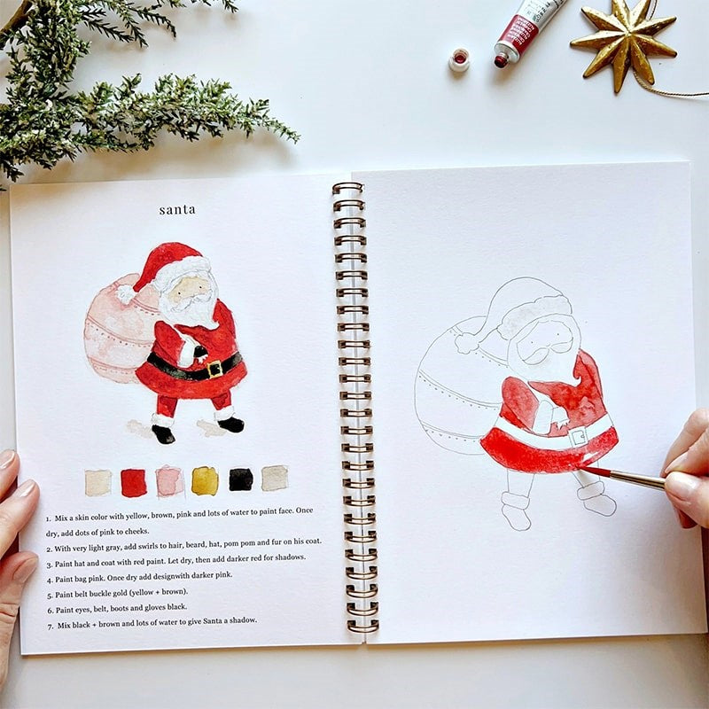 Emily Lex Studio Christmas Watercolor Workbook - model panting inside product