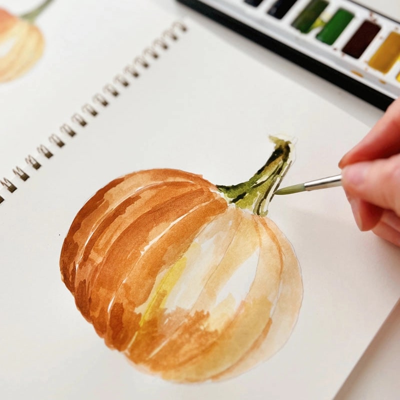 Emily Lex Studio Autumn Watercolor Workbook - model shown painting inside product