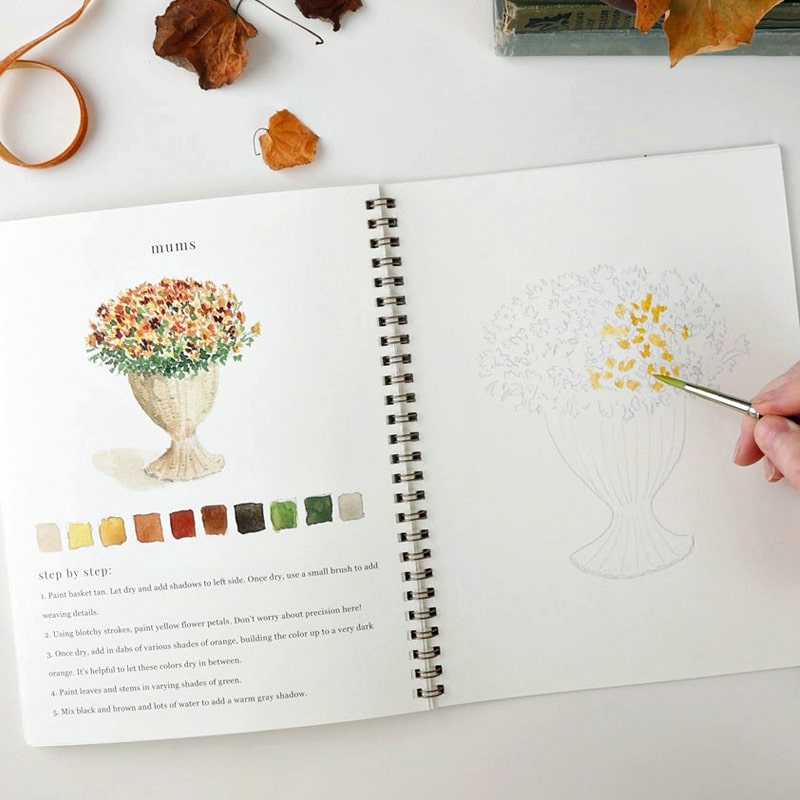 Emily Lex Studio Autumn Watercolor Workbook - model shown painting inside product