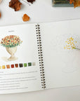 Emily Lex Studio Autumn Watercolor Workbook - model shown painting inside product