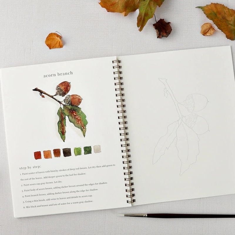 Emily Lex Studio Autumn Watercolor Workbook - model shown painting inside product