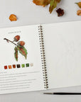 Emily Lex Studio Autumn Watercolor Workbook - model shown painting inside product