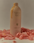 Flamingo Estate Organics Euphoria Hand Soap - product dripping from bottle surrounded by roses