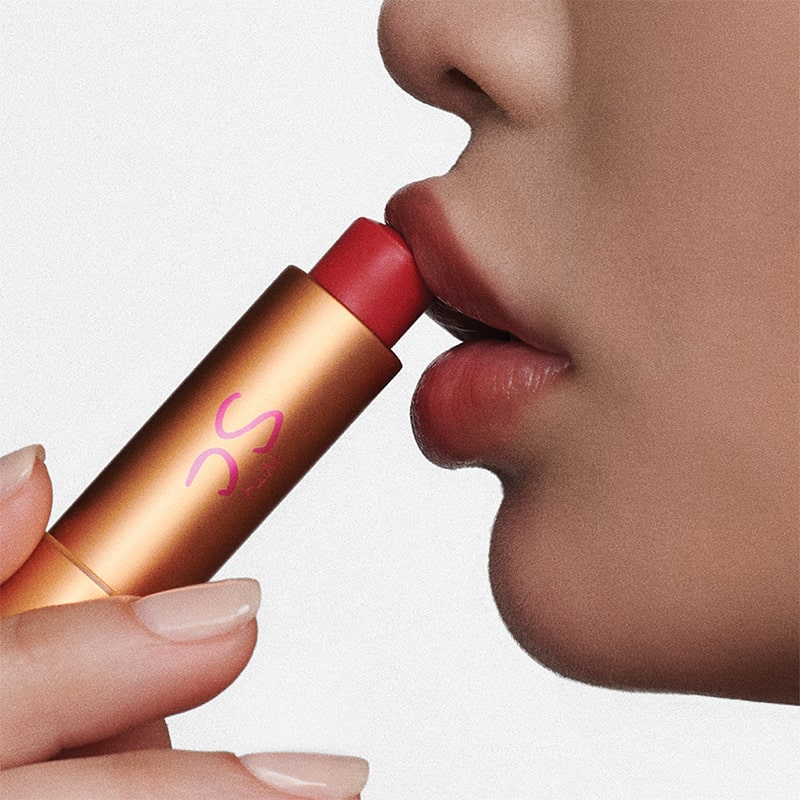Augustinus Bader The Tinted Lip Balm - Shade 1 - model shown holding product to lips