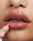 Augustinus Bader The Tinted Lip Balm - Shade 3 - model shown with tinted lip balm on