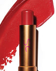 Augustinus Bader The Tinted Lip Balm - Shade 2 - product shown in front of texture color swatch