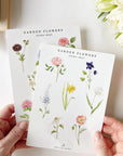 Emily Lex Studio Garden Flowers Sticker Sheet - model holding two sticker sheets with plants near by