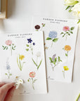 Emily Lex Studio Garden Flowers Sticker Sheet - models hand removing sticker from sheet next to flowers