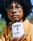 California Naturals Daily Shampoo - model holding product