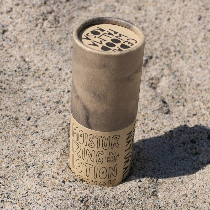 California Naturals Lotion Stick - product shown sticking out of sand