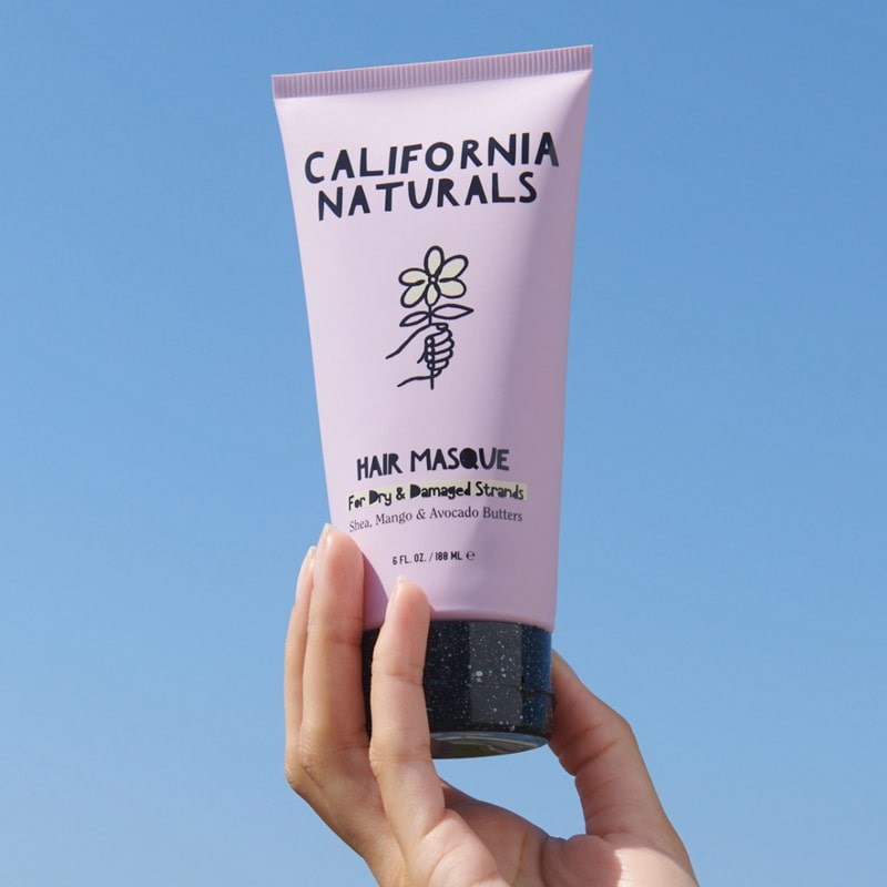 California Naturals Hair Masque - model holding product in air