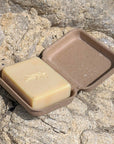 California Naturals Cleansing Body Bar - product shown in packaging on rocks