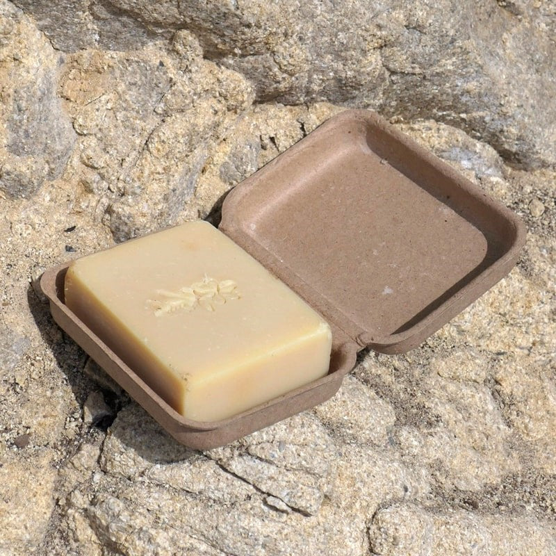California Naturals Scrubbing Body Bar - product in packaging on top of rocks