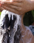 California Naturals Super Moisture Shampoo - model shown rinsing hair with shampoo in it