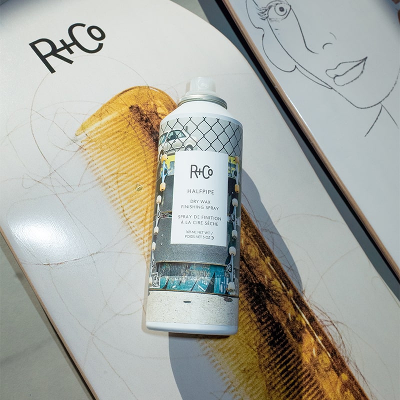 R+Co Halfpipe Dry Wax Finishing Spray - product shown on skateboard decks