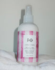 R+Co Candy Stripe Protect + Prep Detangling Spray - product shown on towels
