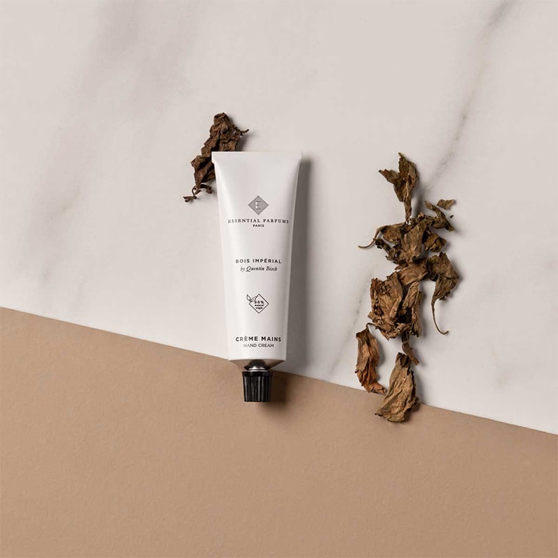 Essential Parfums Hand Cream - Bois Imperial - product next to fragrance ingredients 