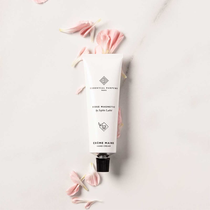 Essential Parfums Hand Cream - Rose Magnetic - product on top of fragrance ingredients