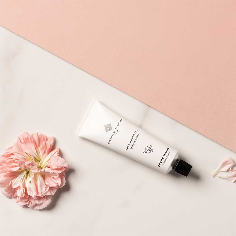 Essential Parfums Hand Cream - Rose Magnetic - product next to flower