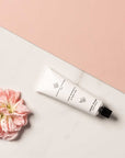 Essential Parfums Hand Cream - Rose Magnetic - product next to flower