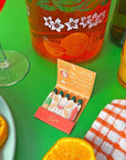 A Shop of Things Spritz Matches - open matchbook shown next to oranges and glasses