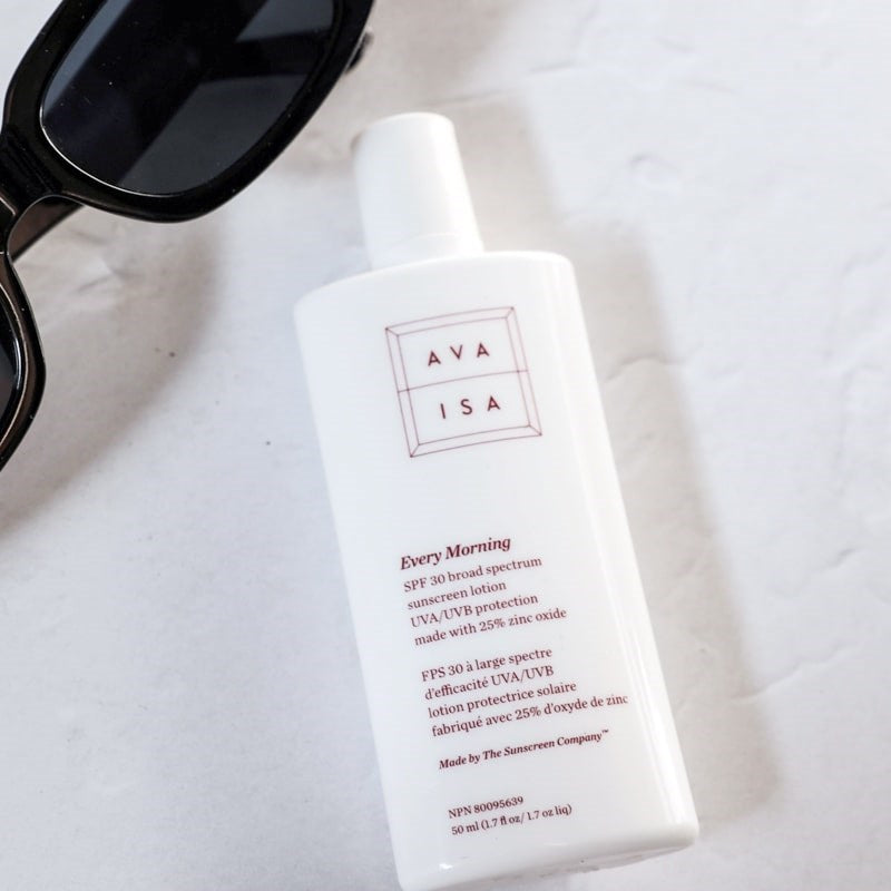 Ava Isa Every Morning Sunscreen SPF 30 - product shown next to sun glasses
