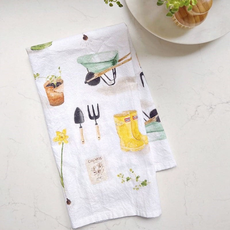 Emily Lex Studio Gardening Tea Towel - product shown folded on table next to dish