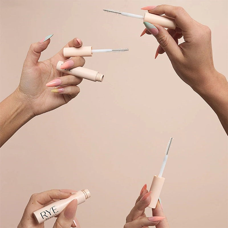 Rye Beauty Brow Milk - models shown holding products without caps