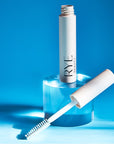 Lifestyle shot of Rye Beauty Brow Milk (6 ml) tube shown open with wand