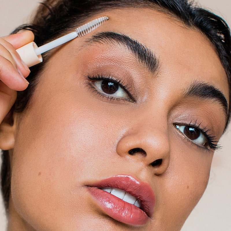 Close up of model applying Rye Beauty Brow Milk to eyebrown