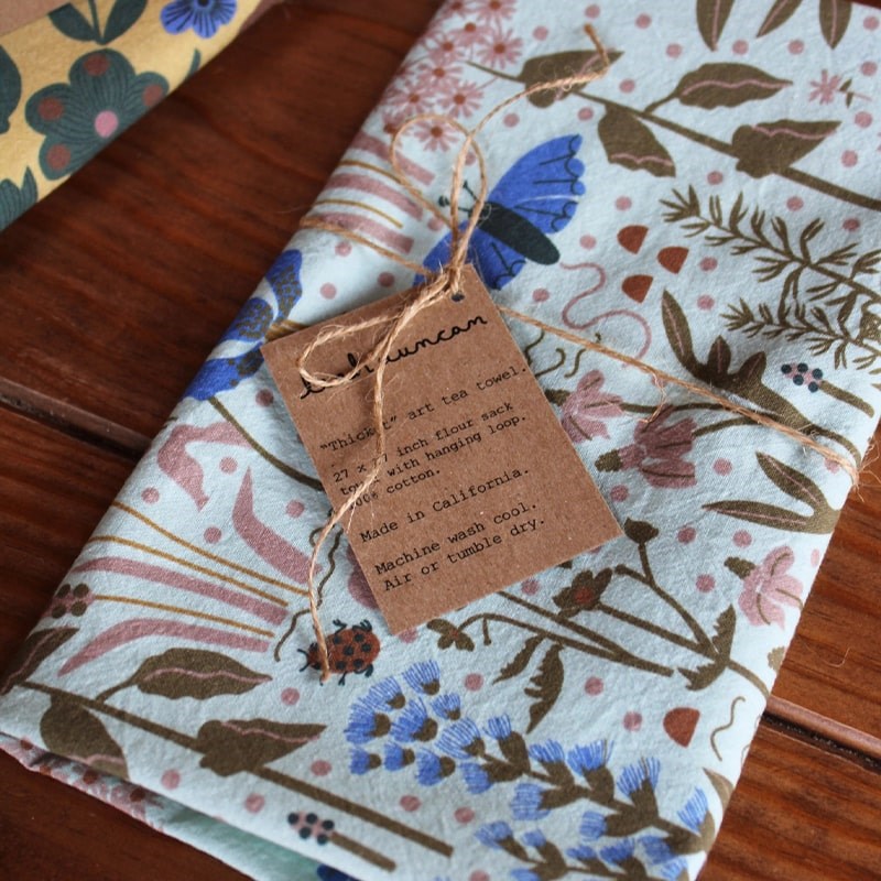 Leah Duncan Thicket Art Tea Towel - product shown wrapped with twine and a info tag