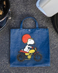 Three Potato Four 3P4 X Peanuts Vintage Market Tote - Snoopy Easy Rider - product shown on ground next to helmet and tire