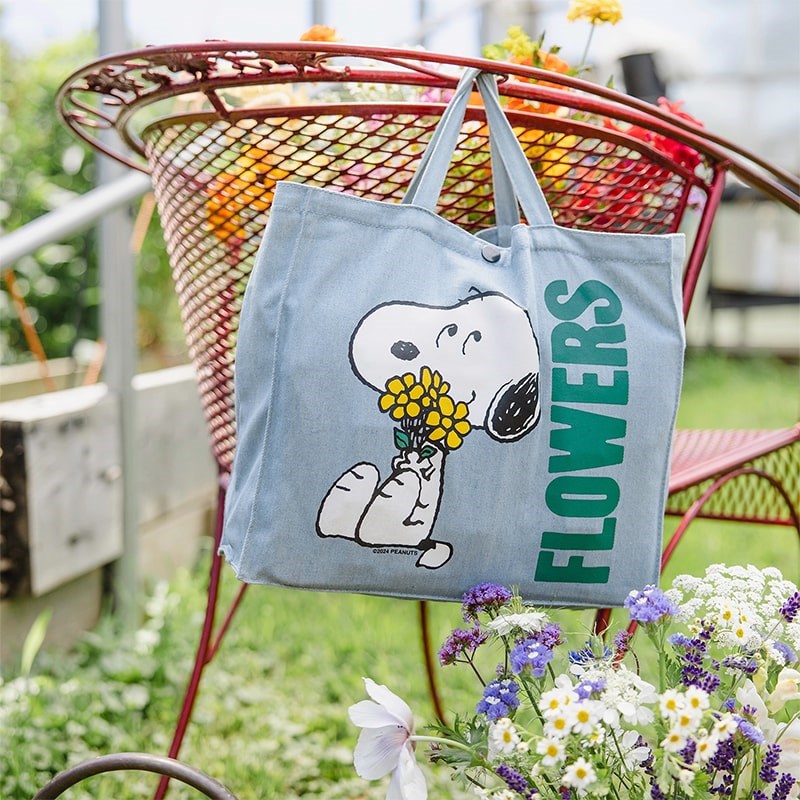 Three Potato Four 3P4 X Peanuts Vintage Market Tote - Snoopy Flower Bouquet - product shown hanging from garden chair 